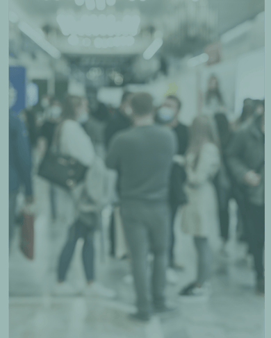 People walking through a crowded trade show exhibition floor